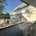 Baan Suksiri Hotel Hua Hin balcony with white chairs overlooking the courtyard and building