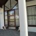 Media Luna Guesthouse in Seydisfjordur entrance with covered porch, glass door, and large windows