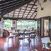 El Refugio Hotel & Spa in Sasaima: open-air dining terrace with garden views and rustic ceiling