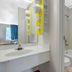 Motel 6 Raleigh North bathroom with sink vanity, mirror, tub-shower, and toilet in Raleigh