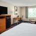 Fairfield by Marriott Inn & Suites Portland West/Beaverton guest room with king bed, desk, TV and seating area in Beaverton