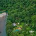 Pacuare Lodge by Böëna in Siquirres, aerial view of jungle lodge beside a river and pool