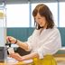 Comfort Hotel Tomakomai in Tomakomai, woman filling a paper cup from a lemon water dispenser