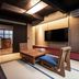 Rinn Shiki Juraku Kyoto suite with tatami seating area, wood table, and wall-mounted TV