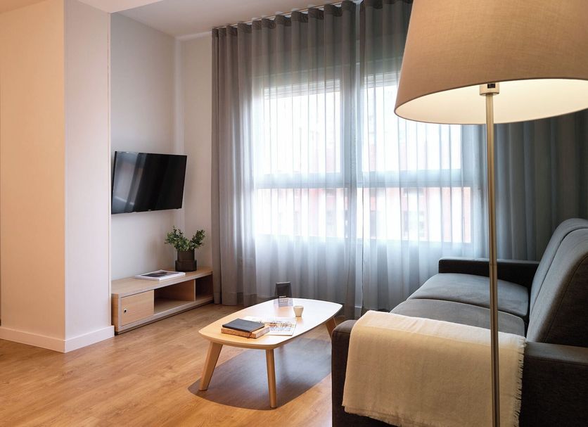 Valenciaflats Ciudad de las Ciencias living area with sofa, coffee table, TV and large window in Valencia