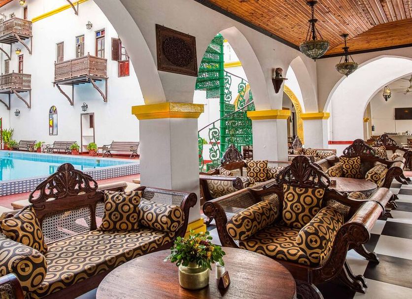 Tembo Palace Hotel in Zanzibar courtyard lounge with pool, arched columns and patterned seating