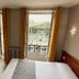 New Hôtel Gare Du Nord room in Paris with desk, bed, and windows overlooking the station plaza