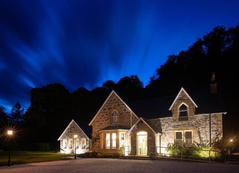 Rokeby Manor in Invergarry at dusk, stone hotel exterior glowing under a deep blue sky