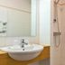 Chalet Hotel Aiguille Blanche Logis bathroom in Les Gets with sink and walk-in shower