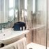 ibis Caen Porte d'Angleterre bathroom with sink, shower, mirror and toiletries in Hérouville-Saint-Clair