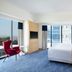 Four Points by Sheraton Surabaya, Tunjungan Plaza guest room with city view, king bed and red chair