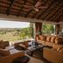 Four Seasons Safari Lodge Serengeti lounge with open views of the Serengeti plains and a dining area