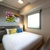 Just Sleep Osaka Shinsaibashi guest room with bed, window and colorful wall art in Osaka