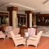 Anemon Ege Hotel in Izmir lobby with pink armchairs, wood floors, and front desk area