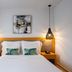 Ariadne Beach - Adults Only guest room in Agios Nikolaos with double bed, bedside lamps and artwork