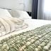Le Muraine Bergamo guest room with neatly made bed, folded towels and soft natural light