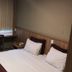 Esplanada Brasilia Hotel in Brasilia guest room with two beds, desk, and curtained window