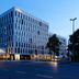 Four Points Flex By Sheraton Essen exterior at dusk with modern multi-story facade on a city street