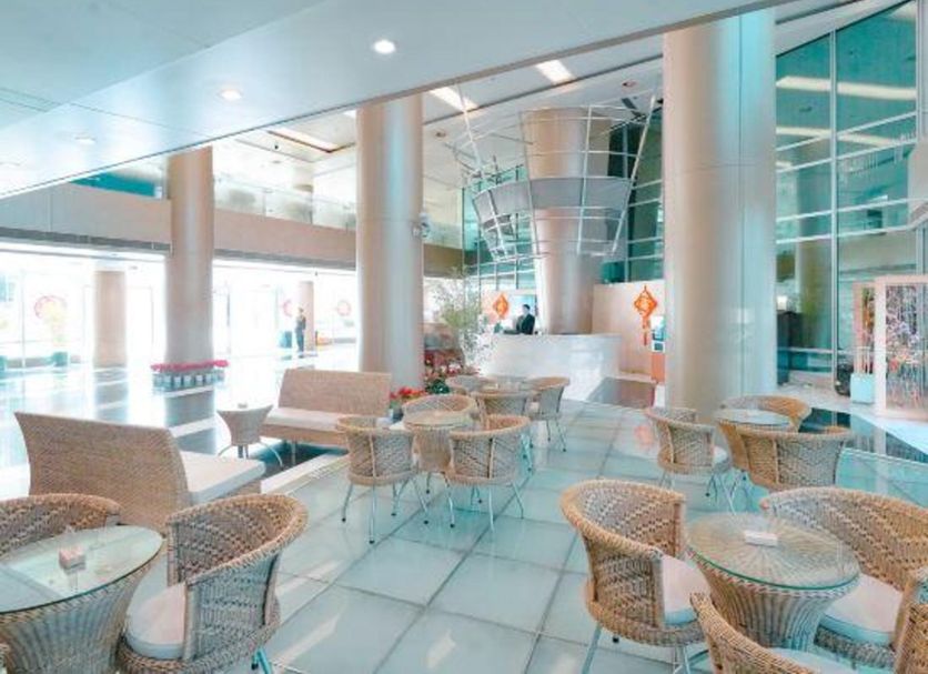 International Bamboo and Rattan Tower Hotel Beijing lobby lounge with wicker seating and pool view