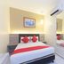 Hotel Suria Malaqa room in Malacca with double bed, red accents, wall mirror and air conditioner