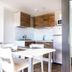 hu I Pini village in Fiano Romano kitchen and dining area with white table, wood cabinets and compact bathroom