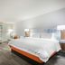 Hampton Inn & Suites Atlanta Buckhead Place guest room with king bed and city view window