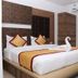 Hotel Arunachala, Tiruvannāmalai: double bed with folded towel swan in a modern guest room