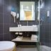 Hanting Hotel Shanghai Xujiahui Metro Station bathroom with sink, mirror, toilet and glass shower in Shanghai