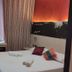Hotel & Restaurant San Marco Ab room in Toscolano Maderno with double bed, desk and striped curtain