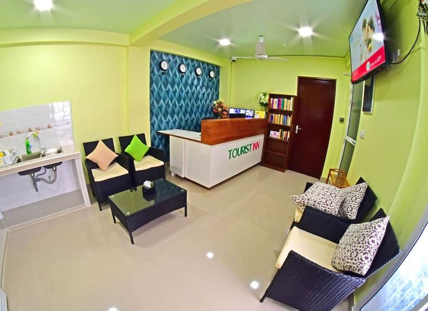 Tourist Inn in Malé lobby with seating, reception desk, and lime green walls