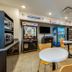 Motel 6 Mankato shows a guest lounge with arcade machine, vending machines, tables and chairs