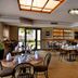 Road Lodge Bloemfontein Airport dining area with tables, chairs, and large windows