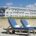 Newport Beach Hotel & Suites in Middletown: beachside loungers with hotel building behind