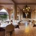 Ksar Ighnda in Aït Ben Haddou dining room with set tables, patterned tile floor and hanging lanterns