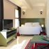 Appart-Hotel Amina Resort & Spa in Marrakech suite with bed, sofa, TV and decorative mirror