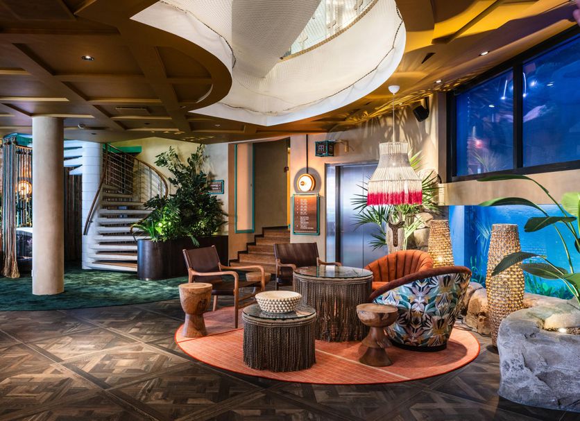 Quality Hotel The Reef in Frederikshavn lobby lounge with tropical decor, seating, and large aquarium display