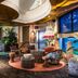 Quality Hotel The Reef in Frederikshavn lobby lounge with tropical decor, seating, and large aquarium display