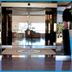 Poseidonia Beach Hotel in Limassol entrance with mosaic planters and a glass-front lobby