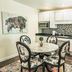 Eo Bungalows, Black Hills in Custer: modern kitchenette with round dining table, floral chairs, and stainless appliances