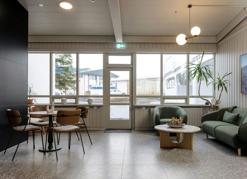 Stracta Hotel Mosfell lounge in Hella with seating, large windows, and mountain view