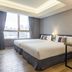 Check Inn New Taipei Luzhou guest room with two beds, desk, and large city-view window in Taipei City