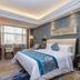 Century Palace Hotel Huiyang in Huizhou guest room with king bed, seating area, and large window