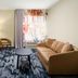 Fairfield Inn & Suites by Marriott Fairfield Napa Valley Area room with sofa, desk, chair, and window light