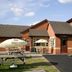 Premier Inn Thurrock East in Grays with outdoor picnic tables, umbrellas and a children’s play area