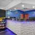 SureStay by Best Western Greenville front desk with blue accent wall and geometric white counter