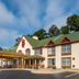 Red Roof Inn & Suites Stafford, VA - Quantico exterior with flagpole and green-roofed entrance in Stafford