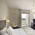 Christofinia Hotel in Ayia Napa guest room with balcony door, seating area, desk and mirror