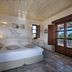 Castello Antico Hotel in Gytheio, guest room with double bed and balcony doors overlooking the sea