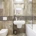 Roxen Hotel&Spa in Chisinau bathroom with bathtub, sink, wall mirror, and mosaic tile accent