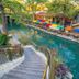 Candlewood Suites Kenedy By IHG canal-side stairway with colorful umbrellas and riverside seating